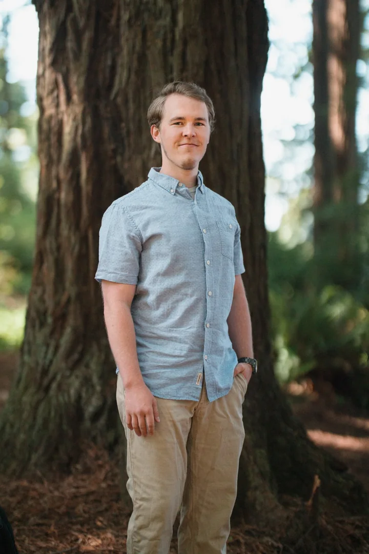 Carson Livingston standing among redwoods